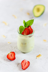Avocado panna cotta with strawberries and mint. Sugar, lactose, gluten free. Healthy food, diet, vegetarian.