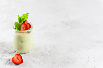 Avocado panna cotta with strawberries and mint in a glass. Sugar, lactose, gluten free. Healthy...