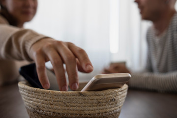 People on meeting without their phones. Digital detox, basket