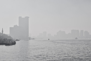 Smog in the polluted city - the embankment of the river Nile and the skyscrappers of Cairo, Egypt
