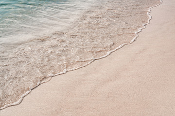 Soft wave of ocean on sandy beach. Copy space