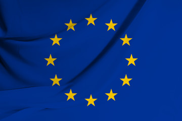The flag of the European Union on fabric texture background. Flag image for design on flyers, advertising.