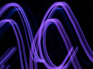 defocused purple neon lighting len flare background in low shutter speed condition can use for overlay, texture and background in graphic design. technology concept.
