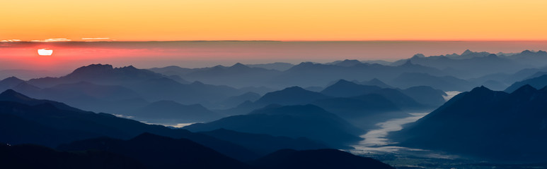 A beautiful and colorful sunrise on the summit of the highest mountain in Germany, Zugspitze at...