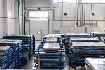 Modern warehouse filled with plastic windows packed in polyethylene