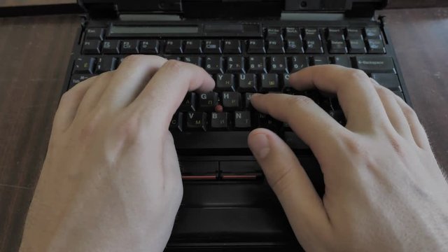 Man Working Behind Retro Vintage Laptop Computer. Top View 