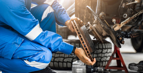 Mechanic Asian man close up fixing repairing car rotor spindle hub automobile vehicle parts...