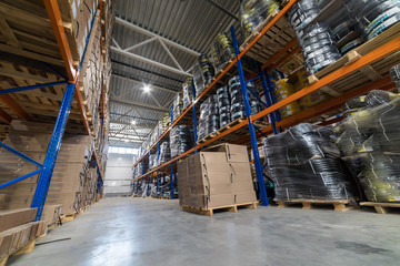 Modern storehouse filled with wires lying on the stands