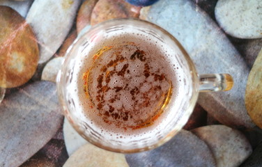glass of beer with foam top view