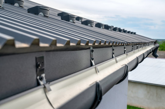 . Gutter system for a metal roof. Holder gutter drainage system on the roof.