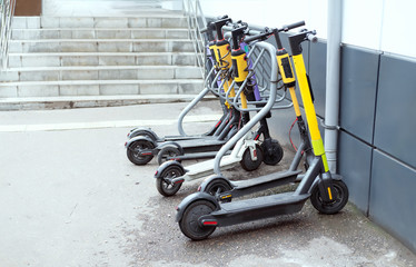Parking for electric scooters.  yellow scooters on the street