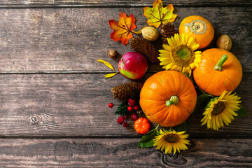 Autumn Background, Thanksgiving table. Pumpkins, sunflowers, apples and fallen leaves. Top view flat lay. Copy space.