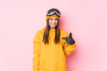 Young caucasian skier woman isolated person pointing by hand to a shirt copy space, proud and confident