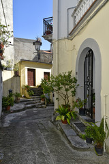 Fototapeta na wymiar A narrow street among the old houses of Aieta, a rural village in the Calabria region.