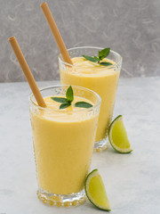 Two glasses of traditional Indian fresh mango lassi dessert