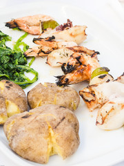 Grilled seafood with potatoes and spinach