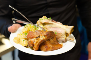 waiter hold on hand plate with meat