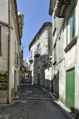 A narrow street among the old houses of Laino Borgo, a rural village in the Calabria region.