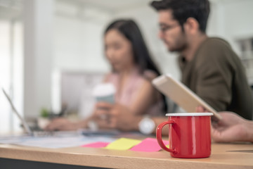 Business team during meeting conference are working documents about the marketing plan and finance sales report of the company with laptop computer