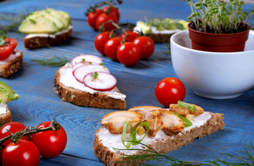 Vegetarian bruschetta assortment on the blue wooden table. Traditional Italian antipasto with various toppings