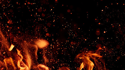 fire flames with sparks on a black background, close-up