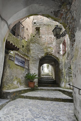 A narrow street among the old houses of Scalea, a rural village in the Calabria region, Italy.