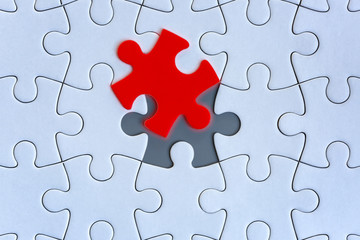 Obraz premium White jigsaw puzzle pieces on gray background