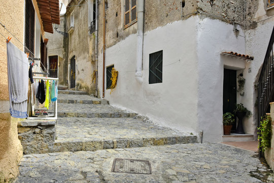 A narrow street among the old houses of Scalea, a rural village in the Calabria region, Italy.