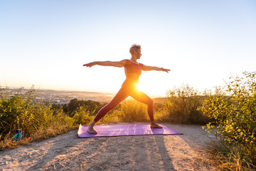 Elderly woman doing yoga Position Explore Warrior Virabhadrasana