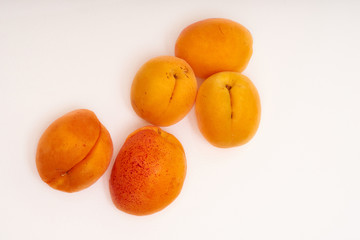 Several apricots on a white background 
