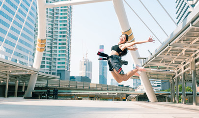 Happy young woman jumping in the city.