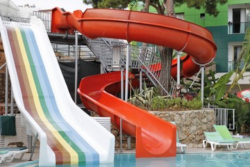 water slides near the pool to ride on vacation in summer