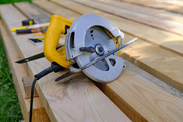 Circular hand electric saw on boards