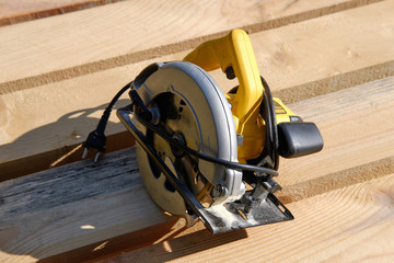 Circular hand electric saw on boards, top view