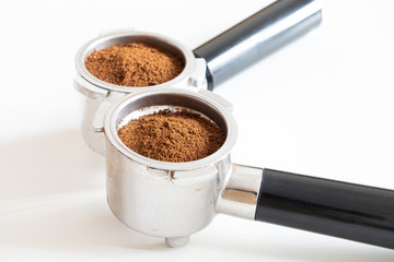 Portafilters filled with ground coffee