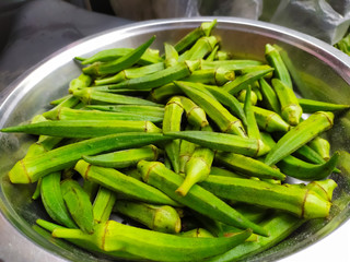 fresh green Ladyfingers in a steel bowl