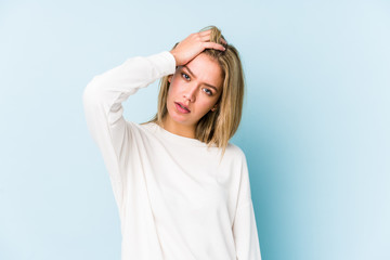 Young blonde caucasian woman isolated tired and very sleepy keeping hand on head.