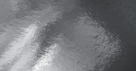 Silver foil texture background with highlights and uneven surface
