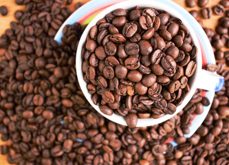 Cup full of coffee beans. Close up. Copy space. Abstract background texture. Coffee beans texture.