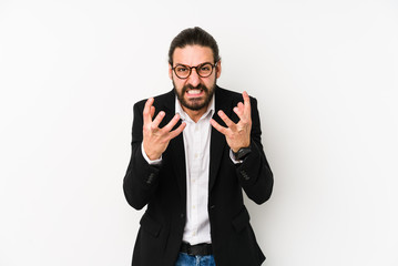 Young caucasian business man isolated on a white background upset screaming with tense hands.
