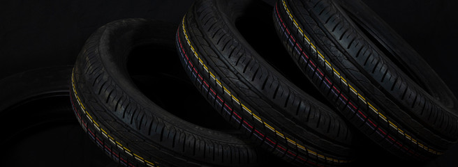Car tires on a black background. Tire and disk stores.