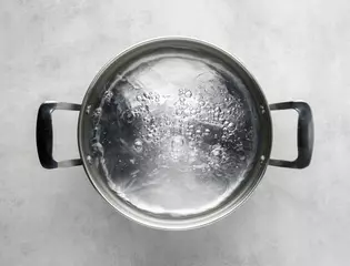 Fotobehang cooking pot of boiling water © Alex