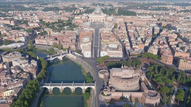 Aerial view of Rome, Castel Sant'Angelo (Castle of the Holy Angel) in foreground and Vatican City in background, bridges over river Tiber - cityscape of capital city of Italy from above, Europe