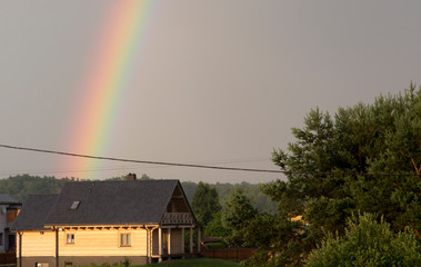 rainbow over a wooden house