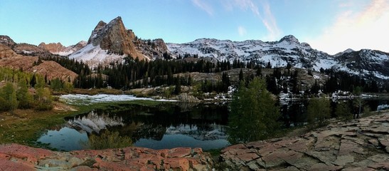 Mountain lake with a reflection and snow