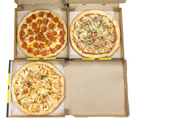 Takeaway food, three italian pizzas with chicken, tomato, cheese, and seafood on traditional thin dough, in a box, place to print, isolated on white background