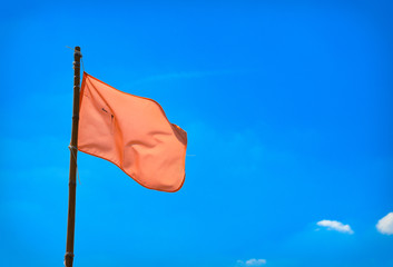 Colorful flags on the line with blue sky in background