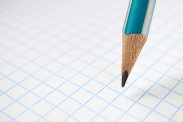 Background on the theme of the new school year with place for text. Pencil and grid notebook sheet...