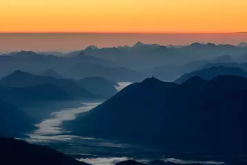Fototapete Küche Ein Bild des Sonnenaufgangs über den Alpenbergen in Deutschland vom höchsten Gipfel Zugspitze.