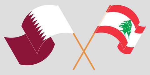 Crossed and waving flags of Lebanon and Qatar